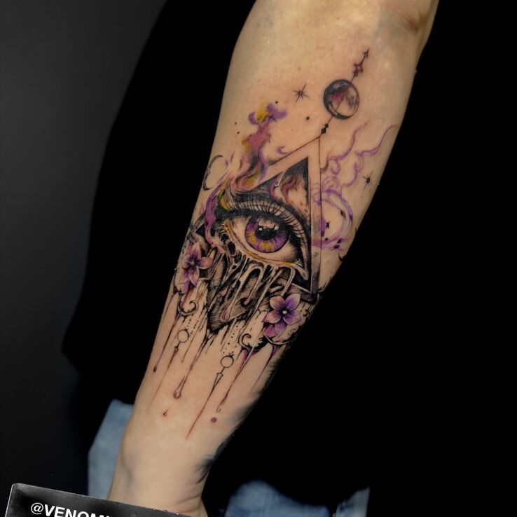 Tattoo Eye of Providence with floral additions in flowers motif and graphic / illustrative style On the arm