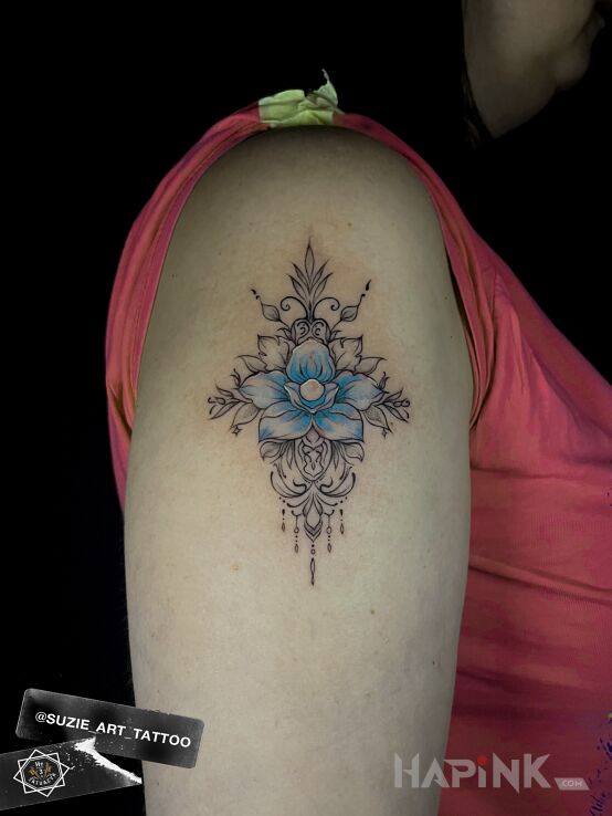 Tattoo Blue flower in flowers motif and graphic / illustrative style on the upper arm