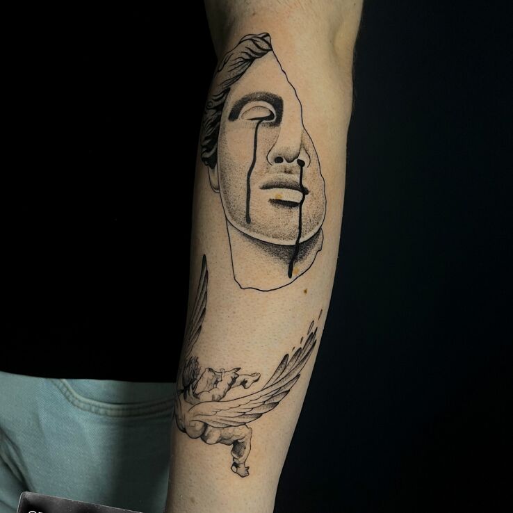 Tattoo Antique sculpture in faces motif and graphic / illustrative style On the arm