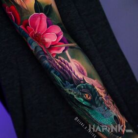 Tattoo Realistic magic dragon on the forearm motif: flowers style: realistic