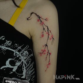 Tattoo Cherry blossom branch on the upper arm motif: flowers style: graphic / illustrative