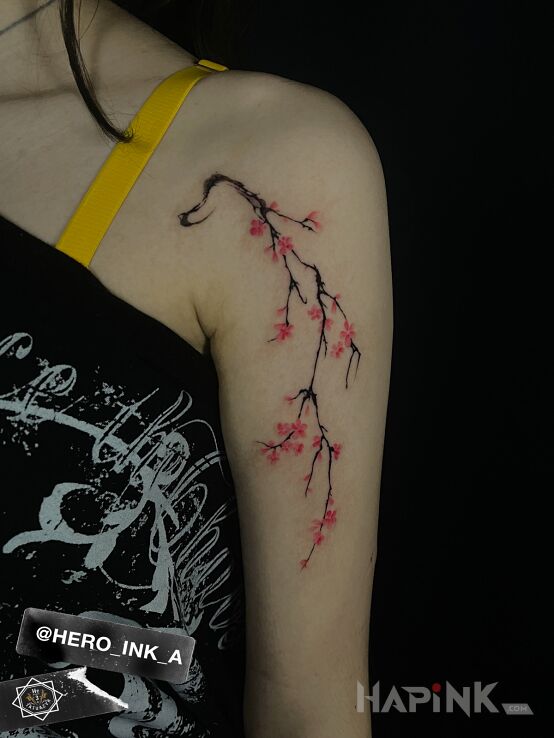 Tattoo Cherry blossom branch in colorful motif and graphic / illustrative style on the upper arm
