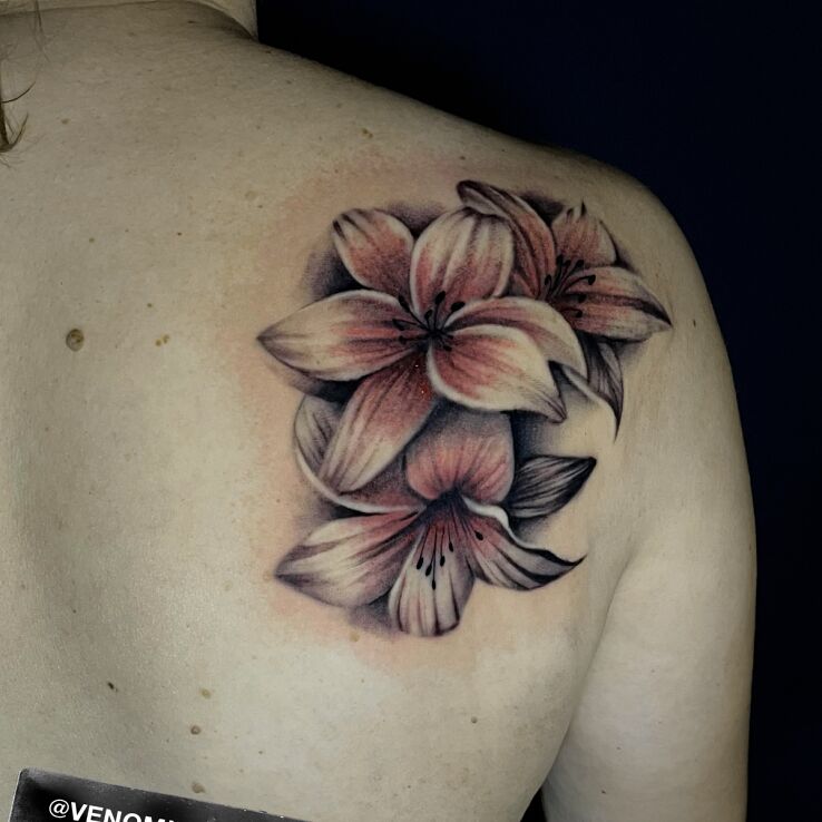 Tattoo Pink Lilies in floral motif and realistic style on the shoulder blades