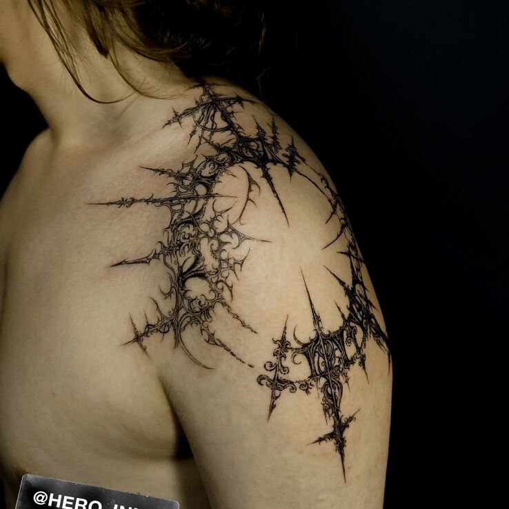 Tattoo Cyberigilism in ornaments motif and graphic / illustrative style on the upper arm