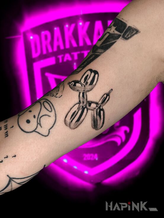 Tattoo Balloon Madness in objects motif and realistic style On the arm