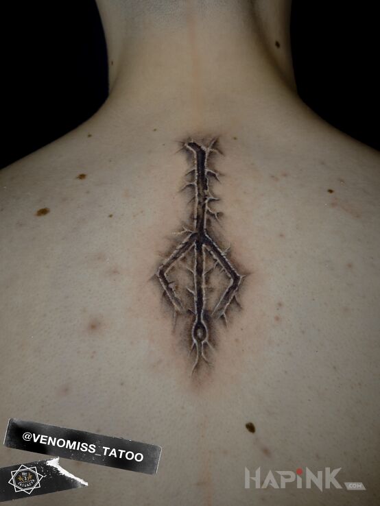 Tattoo Rune in ripped skin motif and graphic / illustrative style on the back