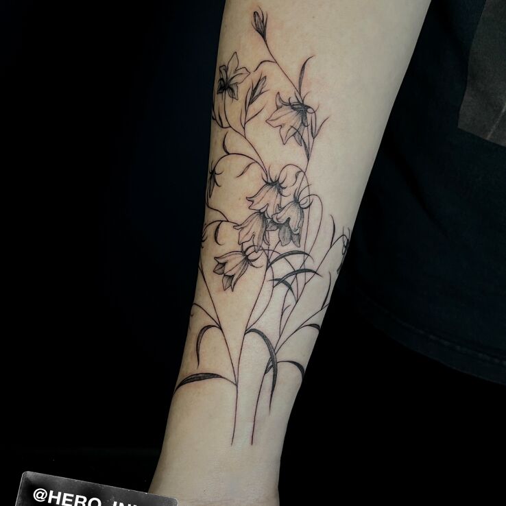 Tattoo Bells in black and gray motif and graphic / illustrative style on the forearm