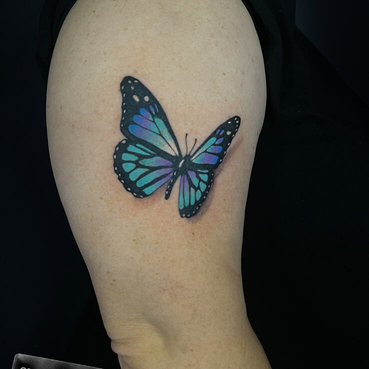 Tattoo Colorful butterfly in realistic style On the arm