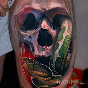 Tattoo Skull and snake on the thigh motif: dark style: realistic