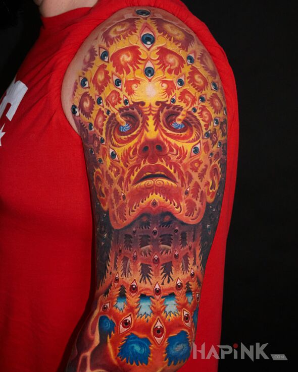Tattoo Oversoul Alexa Greya in religious motif and surrealistic style on the upper arm
