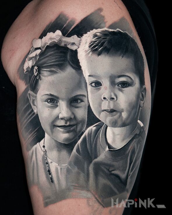 Tattoo Portrait of Children in faces motif and realistic style on the upper arm