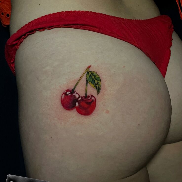 Tattoo Cherries in sexy motif and realistic style on the buttocks