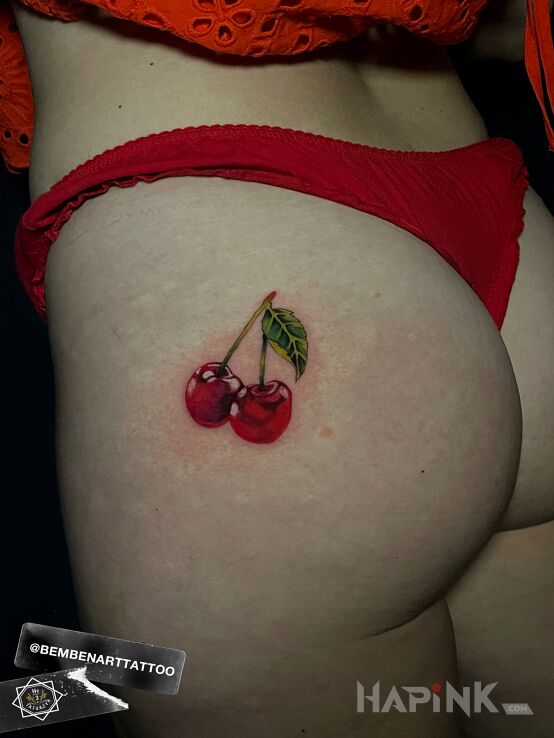 Tattoo Cherries in floral motif and realistic style on the buttocks