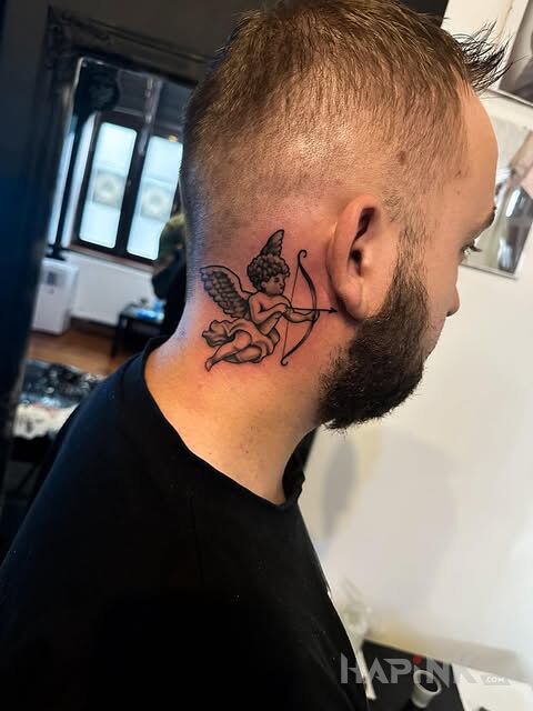 Tattoo Little angel with a bow in angels motif and graphic / illustrative style on the neck