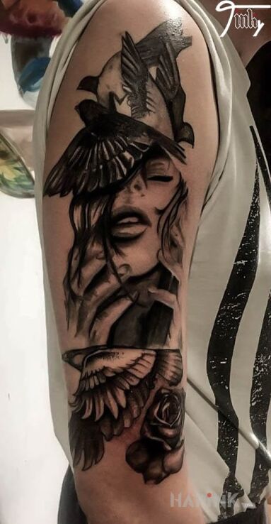 Tattoo Bird mind in characters motif and realistic style on the upper arm