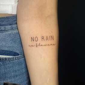 Tattoo No rain no flowers on the forearm style: minimalistic