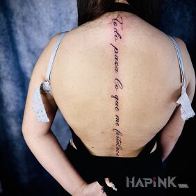 Tattoo Spine tattoo on the back motif: lettering style: calligraphy