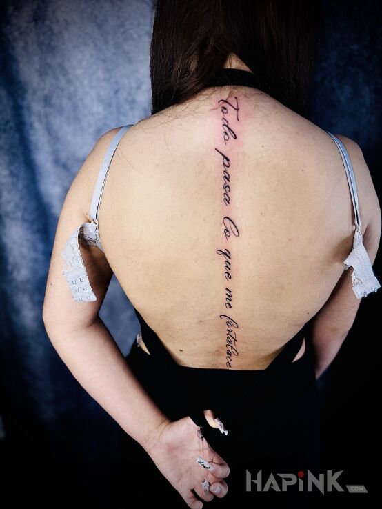 Tattoo Spine tattoo in lettering motif and calligraphy style on the back