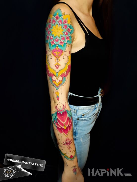 Tattoo Colorful mandala in colorful motif and graphic / illustrative style on the upper arm