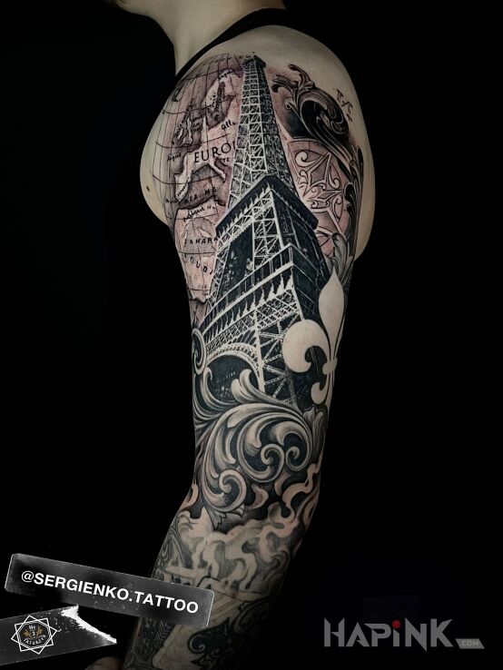 Tattoo Eiffel Tower in black and gray motif and realistic style On the arm