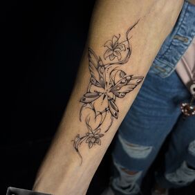 Tattoo Motylek on the forearm motif: flowers style: graphic / illustrative