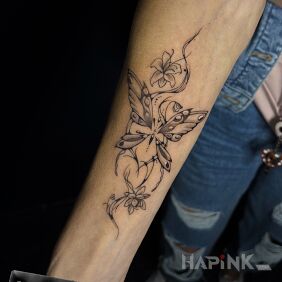 Tattoo Butterfly on the forearm motif: black and gray style: graphic / illustrative