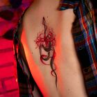Delicate graphic snake with spider lilies on the back