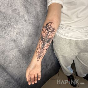 Tattoo Cross with an Angel on the forearm motif: black and gray style: Celtic / Nordic