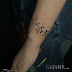 Tattoo Flower bracelet on the forearm motif: flowers style: graphic / illustrative