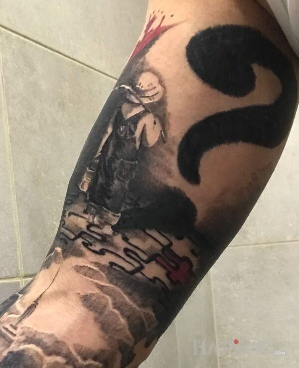 Tattoo Syn :) in characters motif on the upper arm