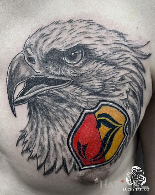 Tattoo Realistic Eagle and Jagiellonia Białystok Crest in black and gray motif and realistic style on the chest