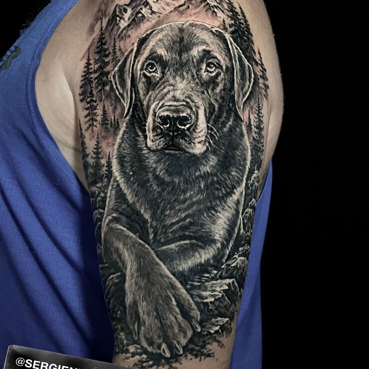 Tattoo Pies na tle gór in nature motif and realistic style On the arm
