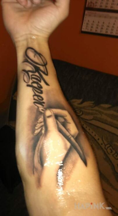 Tattoo Pierworodny in lettering motif on the forearm