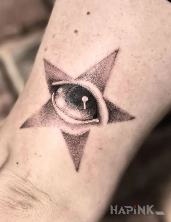 Tattoo All-seeing eye in a star in dotwork style on the elbow
