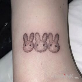 Tattoo Trio of dotted rabbits On the arm style: dotwork