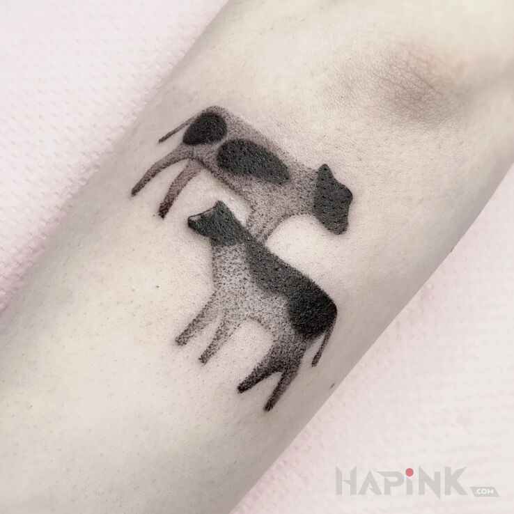 Tattoo Dwie kropkowane krówki in graphic / illustrative style On the arm