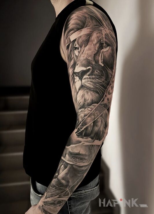 Tattoo Large lion — black & grey realism in animals motif and realistic style on the forearm