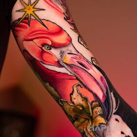 Tattoo Neo-traditional colorful flamingo (healing in progress) on the bicep motif: flowers style: neo-traditional