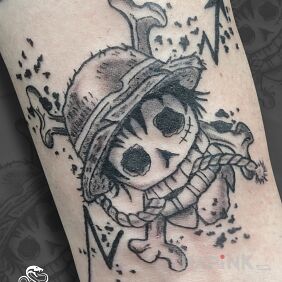 Tattoo One Piece Symbol (Luffy) On the arm motif: skulls style: graphic / illustrative