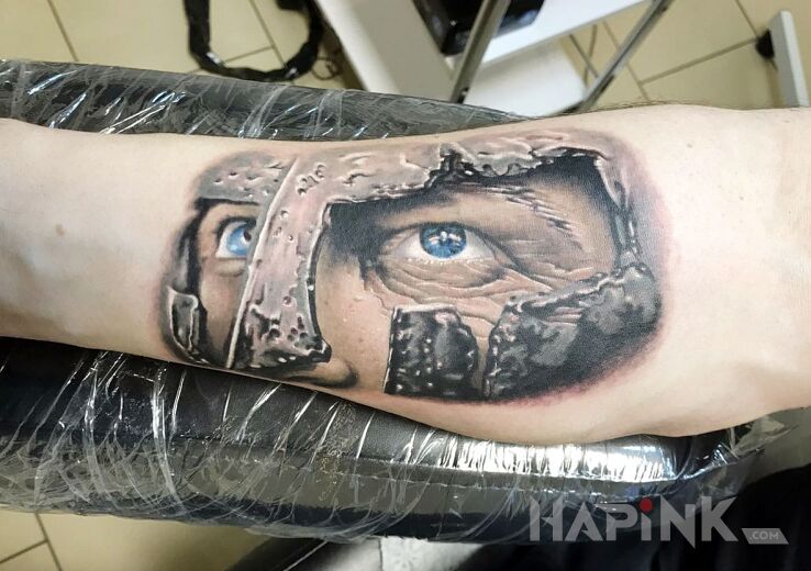 Tattoo Gladiator in colorful motif and realistic style on the forearm