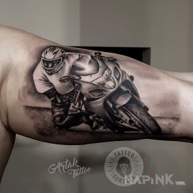 Tattoo Motorcyclist on the bicep motif: motorization style: realistic