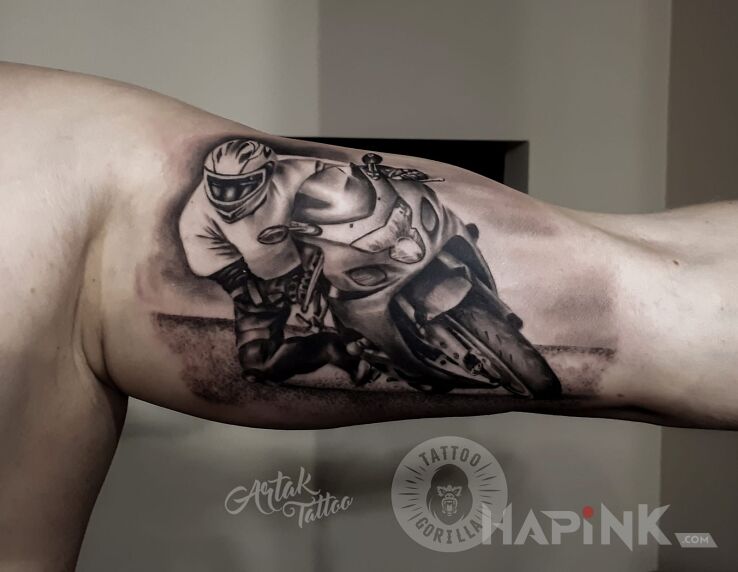 Tattoo Motocyklista in motorization motif and realistic style on the bicep