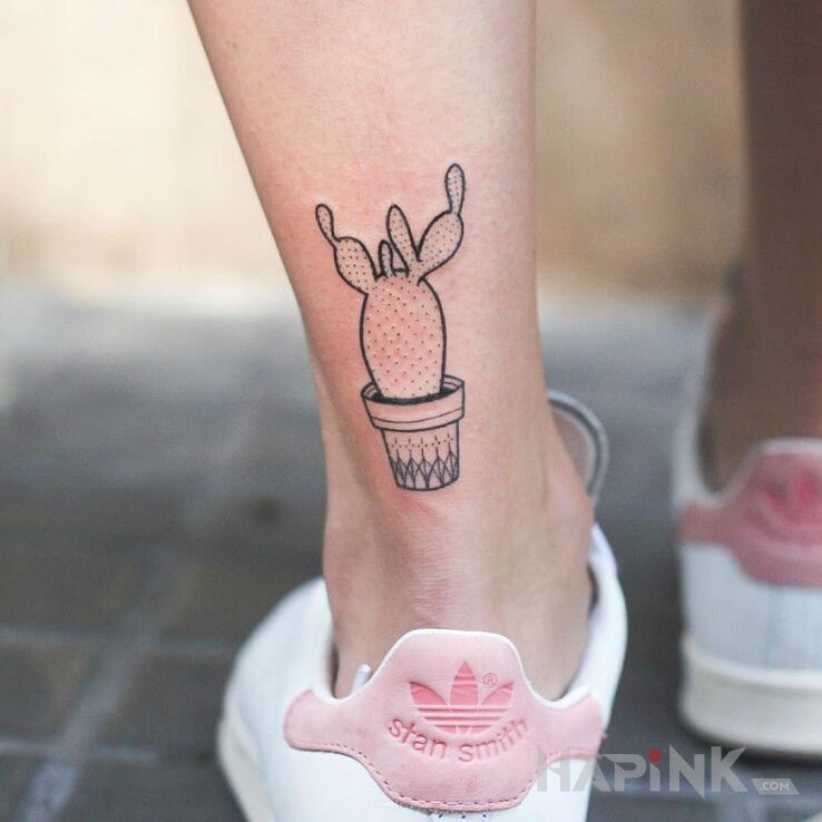 Tattoo Kaktusik in flowers motif on the leg