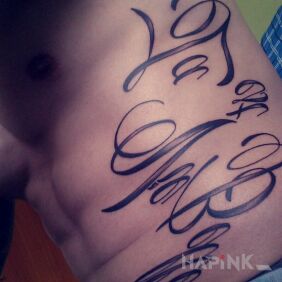 Tattoo La Vie est Belle on the ribs motif: lettering