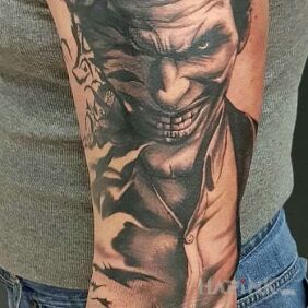Tattoo The Joker and Batman on the upper arm motif: sleeves style: realistic