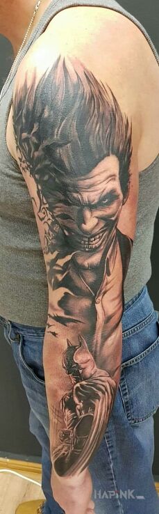 Tattoo Joker i Batman in characters motif and realistic style on the upper arm