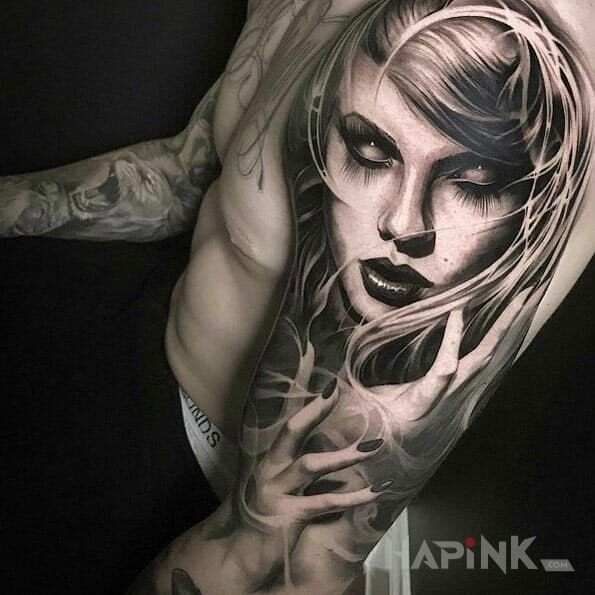 Tattoo Niepokojąca dziewczyna in demons motif and realistic style on the upper arm