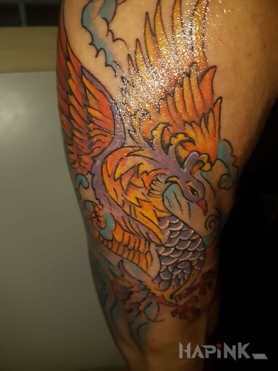 Tattoo Feniks in colorful motif and japanese / irezumi style on the upper arm