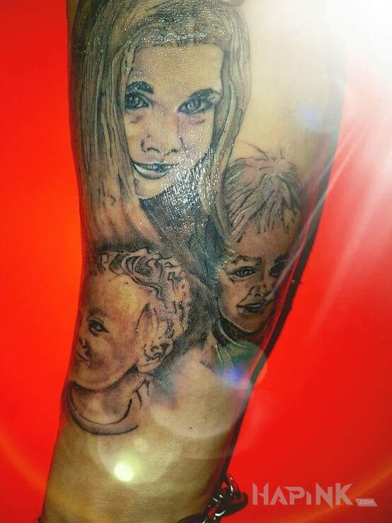 Tattoo Portret in faces motif on the forearm
