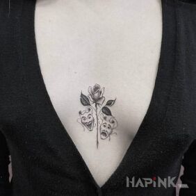 Tattoo Theatrical masks between the breasts motif: faces style: graphic / illustrative